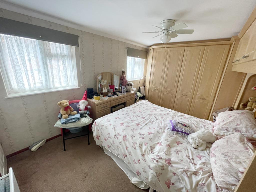 Lot: 45 - TWO-BEDROOM END-TERRACE HOUSE - Bedroom 1 with built in wardrobes and storage